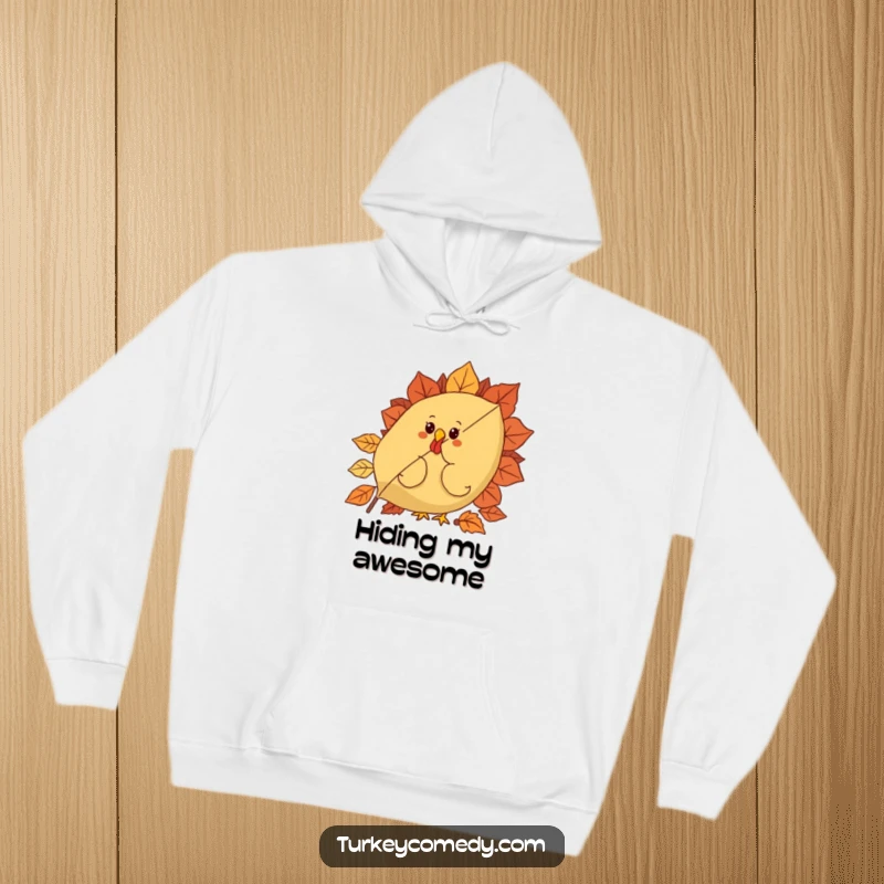 Funny hoodie featuring a curious turkey character hiding behind a large, festive autumn leaf, offering a sense of playful concealment.